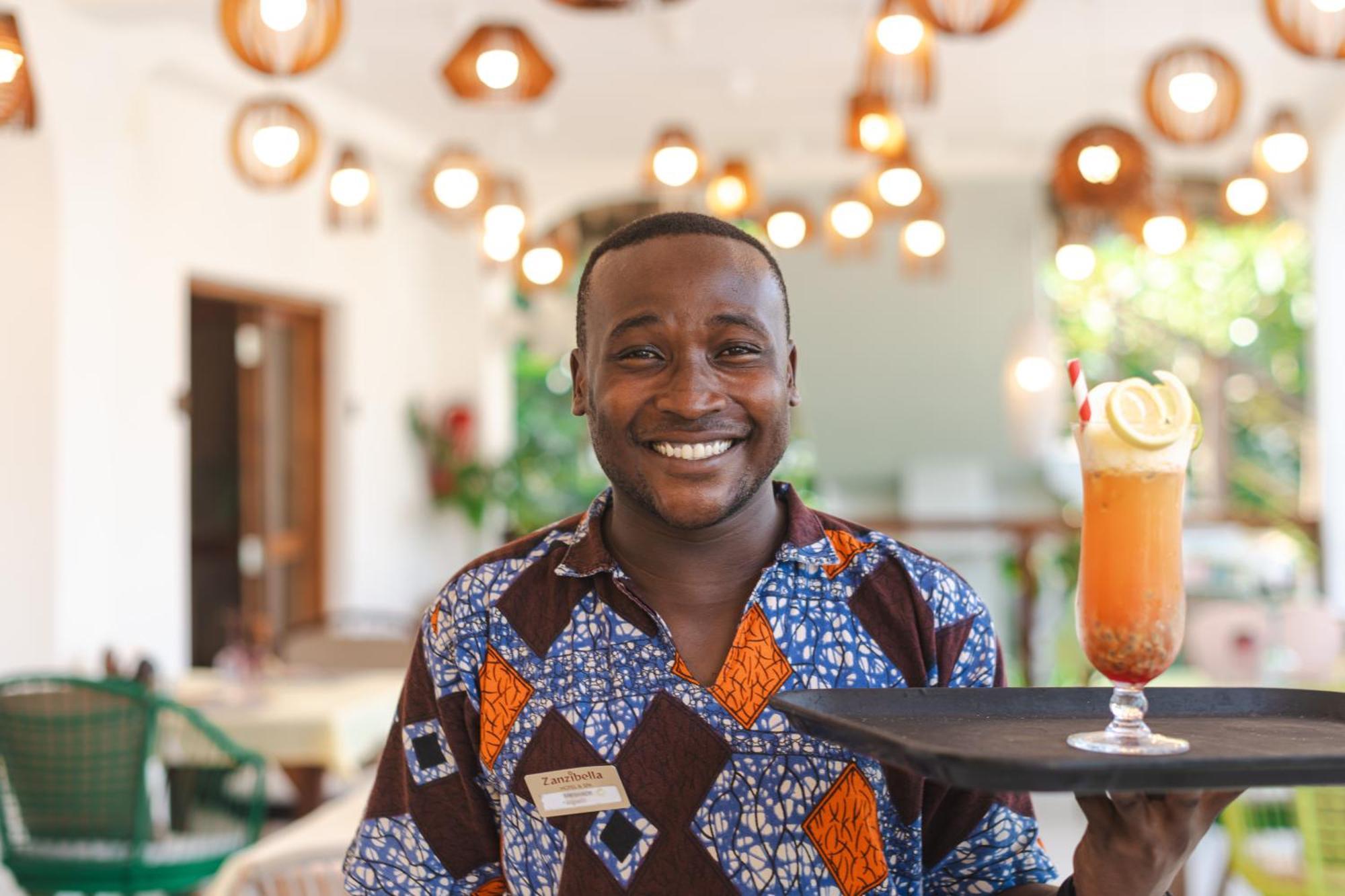 Zanzibella Hotel & Spa Кивенга Екстериор снимка A waiter at the Serena Hotel in Kampala, Uganda